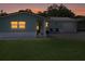 Exterior view of property at dusk, showing the garage and well-kept lawn at 460 4Th S St, Safety Harbor, FL 34695