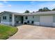 Charming single-story home with a two-toned exterior and well-maintained lawn, perfect for curb appeal at 460 4Th S St, Safety Harbor, FL 34695