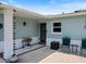 Cozy front porch with charming decor, including chairs and decorative plants, for relaxed outdoor enjoyment at 460 4Th S St, Safety Harbor, FL 34695