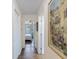 Hallway leads to a bedroom; features hardwood floors and a framed Tampa Bay art piece at 460 4Th S St, Safety Harbor, FL 34695