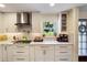 Modern kitchen with white cabinets, marble countertops, and stylish appliances for culinary enthusiasts at 460 4Th S St, Safety Harbor, FL 34695