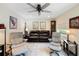 Inviting living area featuring a leather sofa, ceiling fan, and ample natural light at 460 4Th S St, Safety Harbor, FL 34695