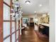 Open floor plan with hardwood flooring, a modern kitchen island, and a seamless flow to outdoor living spaces at 460 4Th S St, Safety Harbor, FL 34695
