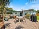 Enjoy this covered patio area with chairs, a table, and a grill at 460 4Th S St, Safety Harbor, FL 34695
