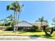 A beautiful clubhouse is surrounded by lush landscaping and palm trees at 4740 Carrington Ct # 4740, New Port Richey, FL 34655
