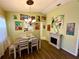 Well-lit dining area with modern chandelier, neutral color palette, and unique artwork at 4740 Carrington Ct # 4740, New Port Richey, FL 34655