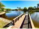 Scenic view from a wooden dock overlooking the tranquil lake and waterfront homes at 4740 Carrington Ct # 4740, New Port Richey, FL 34655