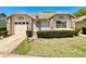 Charming single-story home with brick accents, manicured lawn, and an attached garage at 4740 Carrington Ct # 4740, New Port Richey, FL 34655