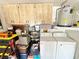 Close-up view of garage storage with washer, dryer, and various household items at 4740 Carrington Ct # 4740, New Port Richey, FL 34655