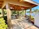 Covered gazebo with tables and chairs overlooking a serene lake at 4740 Carrington Ct # 4740, New Port Richey, FL 34655