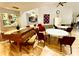Open concept living room with piano, tables, and seating areas for residents to socialize and enjoy community at 4740 Carrington Ct # 4740, New Port Richey, FL 34655