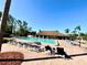 Community pool with lounge chairs and tables, perfect for relaxing on a sunny day at 4740 Carrington Ct # 4740, New Port Richey, FL 34655