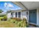 Charming single-story home with stone accents, front yard flower bed, and a blue front door at 507 Hammock Dr, Palm Harbor, FL 34683