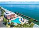 Stunning aerial view of waterfront building with pool, docks, and breathtaking water views at 5225 Coquina Key Se Dr # B, St Petersburg, FL 33705