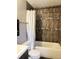 Bathroom featuring shower with decorative tile, toilet, and vanity at 5225 Coquina Key Se Dr # B, St Petersburg, FL 33705