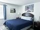 Comfortable bedroom with a queen-size bed, neutral tones, and modern artwork for a relaxing retreat at 5225 Coquina Key Se Dr # B, St Petersburg, FL 33705