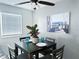 Cozy dining area with a modern table setting, natural light, and stylish coastal-themed wall art at 5225 Coquina Key Se Dr # B, St Petersburg, FL 33705