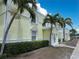 Bright yellow condos trimmed in white offer charming curb appeal with lush tropical landscaping at 5225 Coquina Key Se Dr # B, St Petersburg, FL 33705