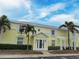 Charming condo building in yellow with mature landscaping and a bright, welcoming entrance at 5225 Coquina Key Se Dr # B, St Petersburg, FL 33705