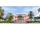 Front of the pink clubhouse with palm trees and well maintained grounds at 5225 Coquina Key Se Dr # B, St Petersburg, FL 33705