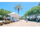 Charming pink guard house at a gated community entrance surrounded by lush greenery and palm trees at 5225 Coquina Key Se Dr # B, St Petersburg, FL 33705