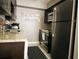 Modern kitchen featuring stainless steel appliances, granite countertops, and dark wood cabinetry with sleek finishes at 5225 Coquina Key Se Dr # B, St Petersburg, FL 33705