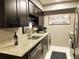 Efficient kitchen design with granite countertops, stainless steel appliances, and modern dark wood cabinets at 5225 Coquina Key Se Dr # B, St Petersburg, FL 33705
