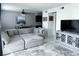 Comfortable living room with sectional sofa, modern TV console, and open dining area, perfect for relaxing at 5225 Coquina Key Se Dr # B, St Petersburg, FL 33705