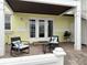 Covered outdoor patio with chairs and a table on a brick surface at 5225 Coquina Key Se Dr # B, St Petersburg, FL 33705