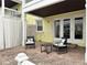Covered outdoor patio with chairs and a table on a brick surface at 5225 Coquina Key Se Dr # B, St Petersburg, FL 33705