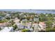 Aerial view of neighborhood homes with red tile roofs, lush trees, and a glimpse of the water in the background at 53 Albemarle Ave, Tampa, FL 33606