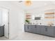 Stylish bar area featuring gray cabinets, marble countertops, and wood shelves, perfect for entertaining guests at 53 Albemarle Ave, Tampa, FL 33606
