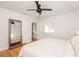 Bright bedroom featuring hardwood floors, a large mirror, and neutral colored walls at 53 Albemarle Ave, Tampa, FL 33606