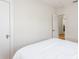Cozy bedroom with white walls and door leading to a bathroom at 53 Albemarle Ave, Tampa, FL 33606