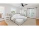 Bright bedroom with a ceiling fan, a large mirror, and white barn door access to the bathroom at 53 Albemarle Ave, Tampa, FL 33606