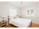 Cozy bedroom with hardwood floors, bedside tables, and natural light from multiple windows at 53 Albemarle Ave, Tampa, FL 33606