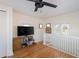 Upstairs bonus room with hardwood floors, white railings and an entertainment center at 53 Albemarle Ave, Tampa, FL 33606