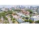 Neighborhood aerial view showcasing diverse homes, lush greenery, and the distant city skyline at 53 Albemarle Ave, Tampa, FL 33606