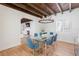 Dining room view shows glass table, exposed wood beam ceilings, and a connection to the living room at 53 Albemarle Ave, Tampa, FL 33606