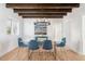 Dining room features a modern chandelier, glass table and exposed wood beam ceiling at 53 Albemarle Ave, Tampa, FL 33606