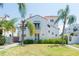 Beautiful view of home with lush landscaping, and iconic palm trees with a red tile roof at 53 Albemarle Ave, Tampa, FL 33606