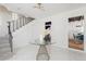 Bright foyer features tiled floor, staircase, modern light fixture and glass-topped table at 53 Albemarle Ave, Tampa, FL 33606