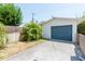 A one car garage with a blue garage door and a paved driveway at 53 Albemarle Ave, Tampa, FL 33606