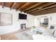 Comfortable living room features a fireplace and exposed wood beam ceiling at 53 Albemarle Ave, Tampa, FL 33606