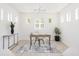 Bright, airy home office with modern light fixture, neutral decor, and natural light from surrounding windows at 53 Albemarle Ave, Tampa, FL 33606