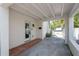 Charming covered portico with white columns and exposed rafter ceiling detail provides shade and style at 53 Albemarle Ave, Tampa, FL 33606