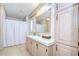Well-lit bathroom features vanity, storage cabinets and shower with tub at 5721 Apache St, Zephyrhills, FL 33542