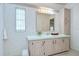 Light bathroom featuring vanity with ample counter space and floral wallpaper at 5721 Apache St, Zephyrhills, FL 33542