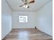 Bright, minimalist bedroom with wood floors and a window providing natural light at 5721 Apache St, Zephyrhills, FL 33542