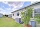 Exterior view of home with manicured lawn and greenery at 5721 Apache St, Zephyrhills, FL 33542
